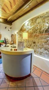 a stone wall in a room with a desk at Great Polonia Jelenia Góra City Center in Jelenia Góra