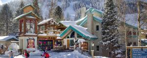 un lodge de ski avec de la neige au-dessus dans l'établissement Alpine Village Suites, à Taos Ski Valley