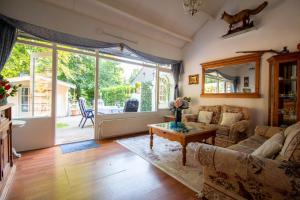 a living room with a couch and a table at Casita Boschberg in Biddinghuizen