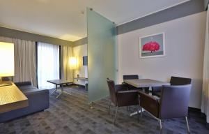 a room with a table and chairs in a hotel room at Best Western Plus Borgolecco Hotel in Arcore