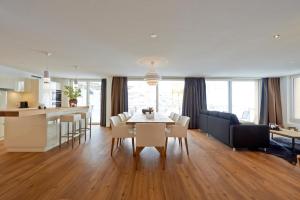 a kitchen and living room with a table and chairs at Hörnligrat Apartments in Zermatt