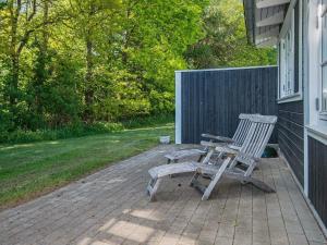 a bench sitting on a patio next to a house at Holiday Home Sandskærvej II in Aabenraa