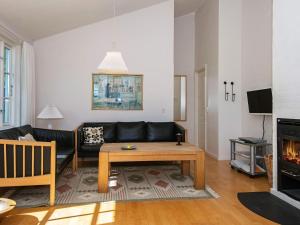 a living room with a couch and a table at Holiday Home Sandskærvej II in Aabenraa