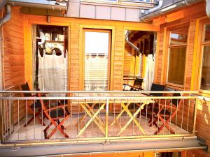 a screened in porch of a house with a balcony at Exklusive ökologische Ferienwohnung ,City, OG in Wernigerode