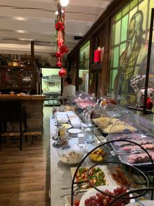 a buffet line with plates of food in a restaurant at Landhotel Villa Foresta in Braunlage