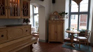 a kitchen with a table and a dining room at Hotel Marmułowski in Wejherowo