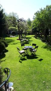 a group of picnic tables and chairs in the grass at Hotel Marmułowski in Wejherowo