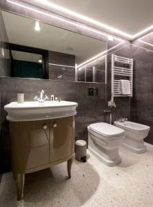 a bathroom with a sink and a toilet and a mirror at Residence Poli Venezia in Venice