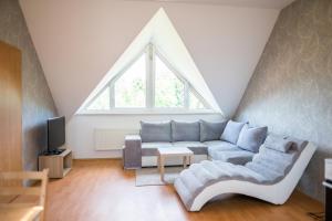 a living room with a couch and a window at Apartmá Kateřina Velké Losiny in Velké Losiny