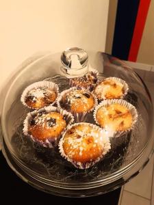 a glass plate with cupcakes in muffins at B&B Guest Armonie in Torre del Greco