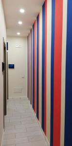 a hallway with red white and blue striped wall at B&B Guest Armonie in Torre del Greco