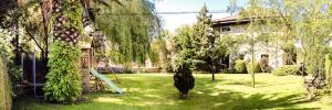 a yard with a slide and trees and a house at Apartamentos Los Hidalgos in Santillana del Mar