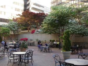 personas sentadas en mesas en un patio con árboles en Holiday Inn Washington Capitol-National Mall by IHG, en Washington