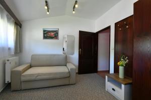 a living room with a chair and a door at Pension Tenis - Centrum in Český Krumlov