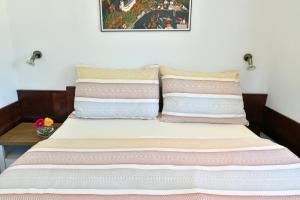 a bed with two pillows on top of it at Pension Tenis - Centrum in Český Krumlov