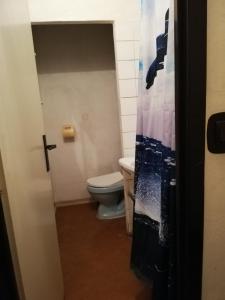 a bathroom with a toilet and a door open at ABC Hotel Nitra in Nitra