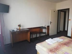 a hotel room with a desk and a bed at ABC Hotel Nitra in Nitra