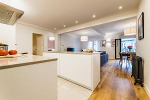 a kitchen with white countertops and a dining room at ZABALETA SUITE by Sweet Home SS Rentals in Donostia-San Sebastián