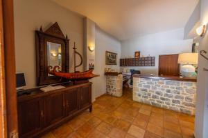 a room with a counter with a mirror and a sink at Kastro Maini in Areopolis