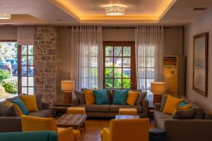 a living room with couches and colorful pillows at Kastro Maini in Areopolis