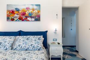 a bedroom with a bed and a painting on the wall at A casa di Monachella in Gaeta