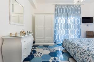 a bedroom with blue and white flooring and a bed at A casa di Monachella in Gaeta