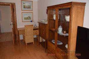 a room with a desk and a wooden cabinet at Café Burgstraße in Wernigerode