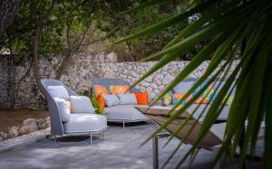 two chairs and a table on a patio at Pine Beach Villa in Hvar