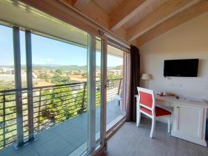 Cette chambre dispose d'un balcon, d'un bureau et d'une télévision. dans l'établissement Nuova Opera Rooms, à Vérone