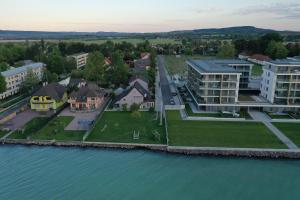 une vue aérienne sur une maison à côté de l'eau dans l'établissement Hullám Apartman, à Balatonlelle