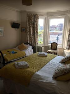 a hotel room with two beds and a window at Old Church House in Newport