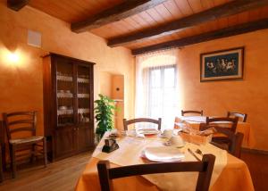 a dining room with a table and chairs and a window at B&B Linu Ruiu in Santu Lussurgiu