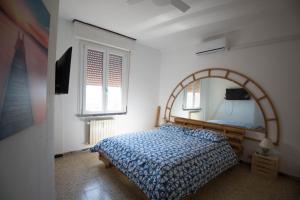 a bedroom with a bed and a mirror at CinqueTerre Sea in San Terenzo