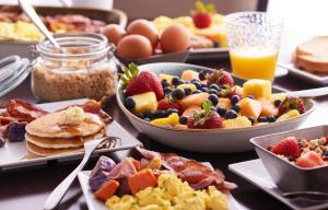 - une table avec des assiettes de produits pour le petit-déjeuner et des boissons dans l'établissement Hyatt Place National Harbor, à National Harbor