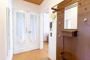 a hallway with a white door with curtains at An der Abzucht in Goslar