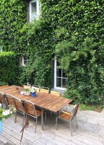 a wooden table and chairs sitting on a patio at B&B La ferme du doux in Libramont