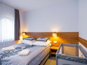 a hotel room with two beds and a desk at Strama Kościelisko in Kościelisko