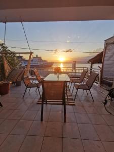 a patio with a table and chairs and a cruise ship at Elli's House in Keramotí