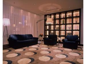 a living room with two chairs and a rug at Mizusawa Ground Hotel - Vacation STAY 84945 in Oshu