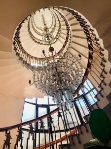 a large chandelier hanging from a ceiling at Hotel Victoria in Cluj-Napoca