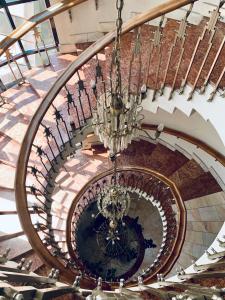 a spiral staircase in a building with a chandelier at Hotel Victoria in Cluj-Napoca