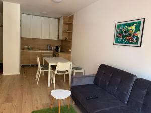 a living room with a couch and a table at Apartmán Jeleň Chopok Juh-Trangoška in Tale