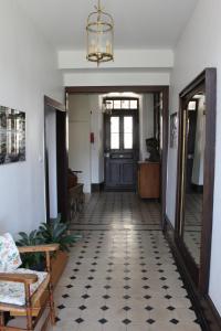 a hallway with a door and a table and a chair at Ancien Presbytère Albert Schweitzer in Gunsbach