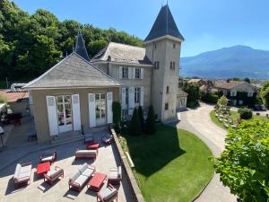 an aerial view of a house with chairs and a yard at Château & Spa De La Commanderie in Eybens