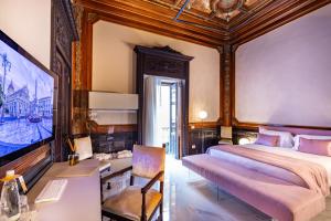 A bed or beds in a room at Palazzo Marletta Luxury House Hotel