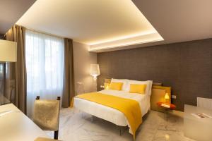 A bed or beds in a room at Palazzo Marletta Luxury House Hotel