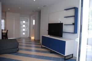 a living room with a flat screen tv on a wall at Apartamentos Sunway Arizona in Sitges