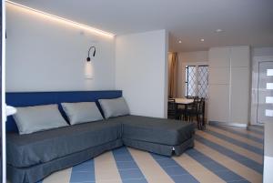 a bedroom with a bed and a dining room at Apartamentos Sunway Arizona in Sitges