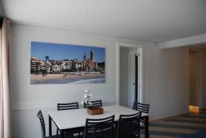 a dining room with a white table and chairs at Apartamentos Sunway Arizona in Sitges