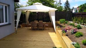 a patio with a table and an umbrella at Apartament KAOLA in Jelenia Góra